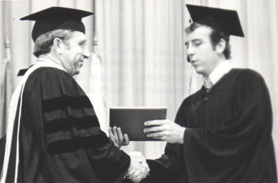 Paul Bubb is shown receiving his history degree in 1979 from Monmouth president DeBow Freed.