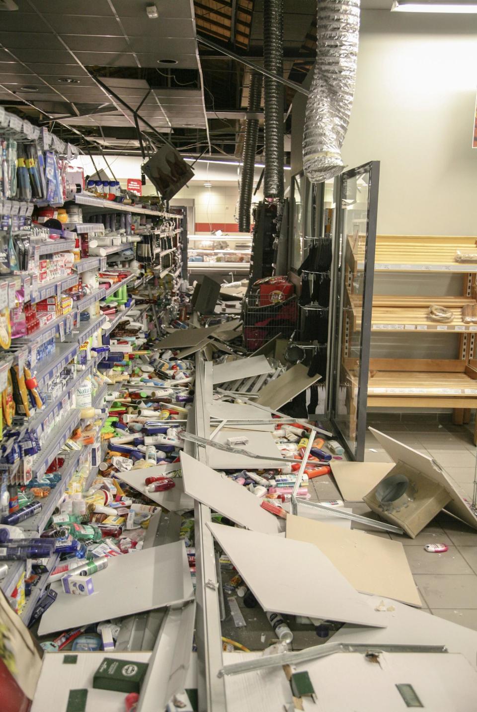 In this Sunday, Jan. 26, 2014 image earthquake damage litters the floor of supermarket in the island of Kefalonia, western Greece. Schools have been ordered closed and a state of emergency has been declared on Monday, Jan. 27, 2014 on the island of Kefalonia, Ionian Sea, after an earthquake damaged homes and injured at least seven people. Hundreds of the island residents slept in their cars after Sunday's magnitude 5.8 temblor struck near the town of Lixouri on the western Greek island, and was followed by aftershocks as powerful as magnitude 5.2, according to the Institute of Geodynamics in Athens. (AP Photo/InTime News)