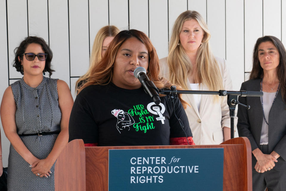 Samantha Casiano, in the center, speaks during a press conference outside the Travis County Courthouse on July 19, 2023 in Austin, Texas.Suzanne Cordeiro / AFP via Getty Images