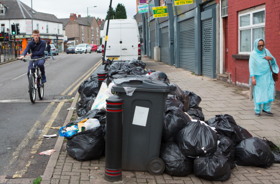 <em>Rubbish bags are now threatening to block doorways and spill onto the road (SWNS)</em>