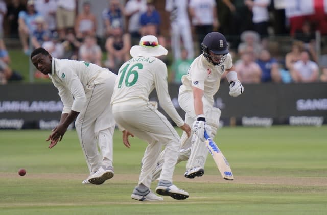 Pope runs a single as South Africa’s Kagiso Rabada, left, and Keshav Maharaj field