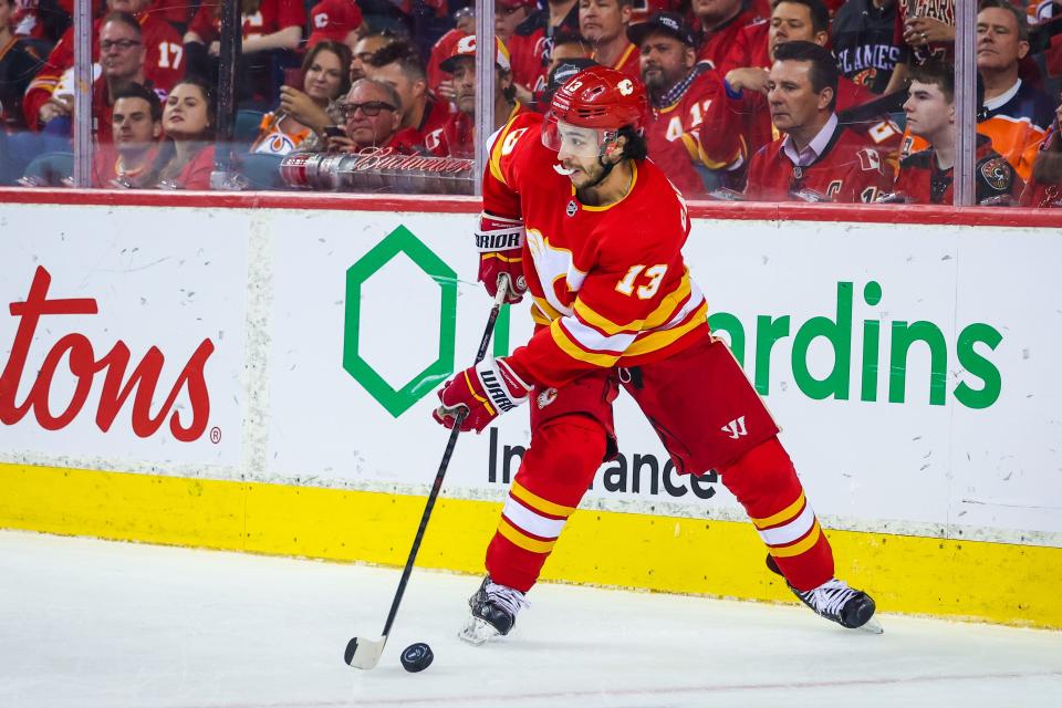 May 26, 2022; Calgary, Alberta, CAN; Calgary Flames left wing Johnny Gaudreau (13) controls the puck against the Edmonton Oilers during the first period in game five of the second round of the 2022 Stanley Cup Playoffs at Scotiabank Saddledome. Mandatory Credit: Sergei Belski-USA TODAY Sports