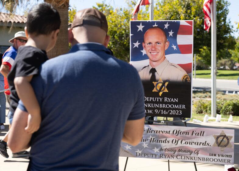 PALMDALE, CA - SEPTEMBER 18: A memorial for Los Angeles County Dep. Ryan Clinkunbroomer stands at the Palmdale Sheriff's Station on Monday, Sept. 18, 2023. Sheriff Robert Luna announced the arrest of a suspect in the shooting death of the deputy. (Myung J. Chun / Los Angeles Times)