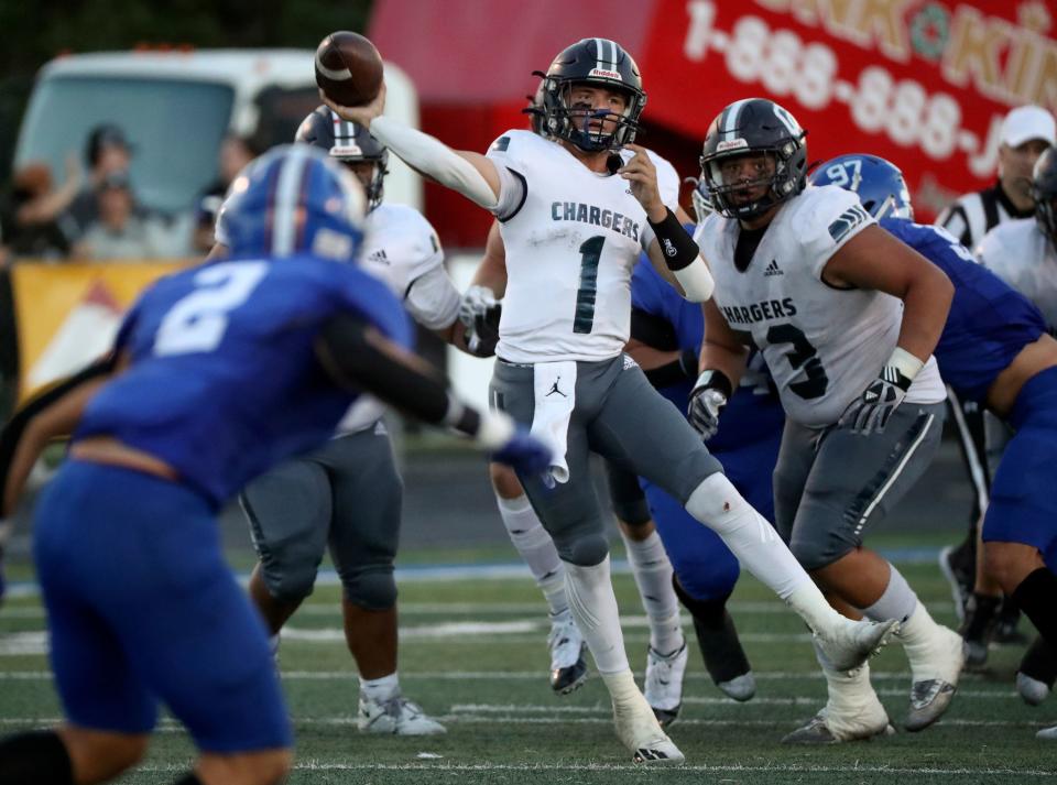 Corner Canyon quarterback Isaac Wilson throws a pass during a game against Bingham at Bingham High School in South Jordan.