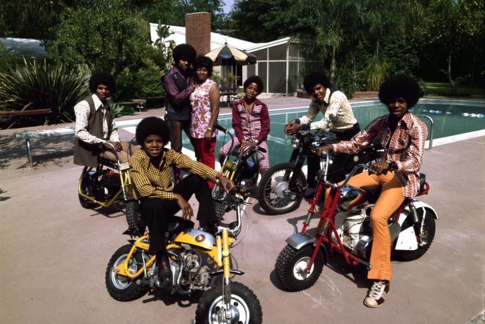 <p>The Jackson 5 pose with minibikes and their parents at their pool in Encino, California in 1971. </p>