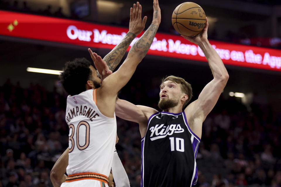 Sacramento Kings forward Domantas Sabonis (10) shoots against San Antonio Spurs forward Julian Champagnie (30) during the first half of an NBA basketball game in Sacramento, Calif, Thursday, March 7, 2024. (AP Photo/Jed Jacobsohn)