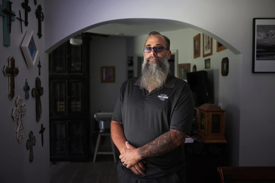 Larry Pfaff, 58, shown at his Jacksonville home, wrote a brutally honest obituary about his father, who he said was an abusive alcoholic who abandoned the family. Published in The Florida Times-Union, the piece drew jeers from some readers but resonated with many others who said they wished they had told similar truths about their parents.