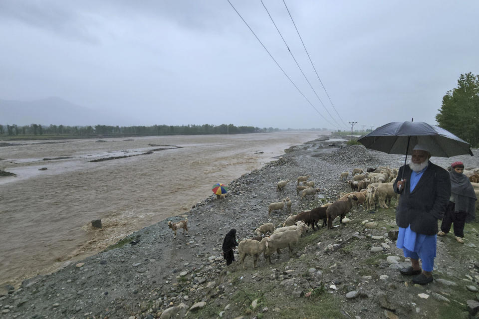 A Pakistani looks at the Swat river, which is overflowing due to heavy rains in the area, in Mingora, the main town Swat Valley, Pakistan, Monday, April 15, 2024. Lightening and heavy rains killed dozens of people, mostly farmers, across Pakistan in the past three days, officials said Monday, as authorities declared a state of emergency in the country's southwest following an overnight rainfall to avoid any further casualties and damages. (AP Photo/Sherin Zada)