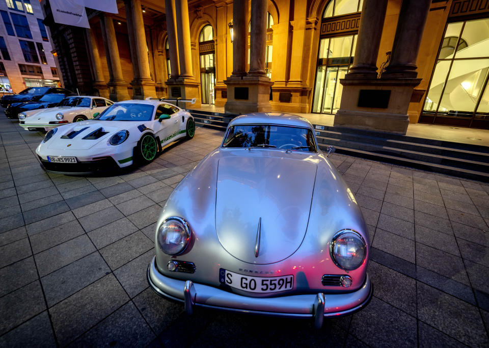 Porsche cars are lined up in front of the stock market at the start of Porsche's market listing in Frankfurt, Germany, Thursday, Sept. 29, 2022. In front a Porsche 356. (AP Photo/Michael Probst)