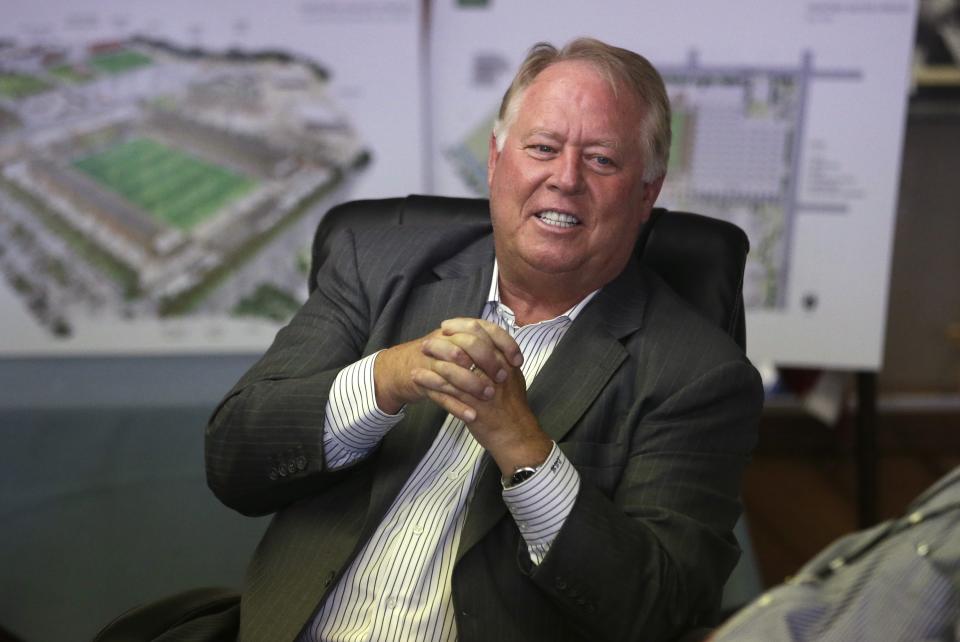 Dell Loy Hansen sits in an office