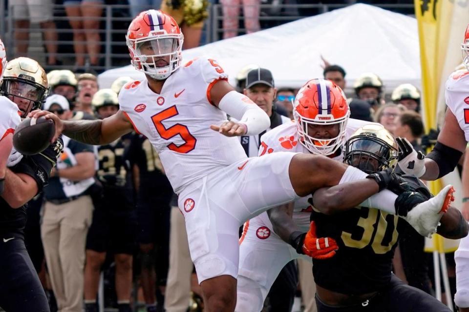 Clemson quarterback DJ Uiagalelei (5) looks to pass as Wake Forest defensive lineman Jasheen Davis (30) tries to tackle him during their game in Winston-Salem, N.C., Saturday, Sept. 24, 2022.