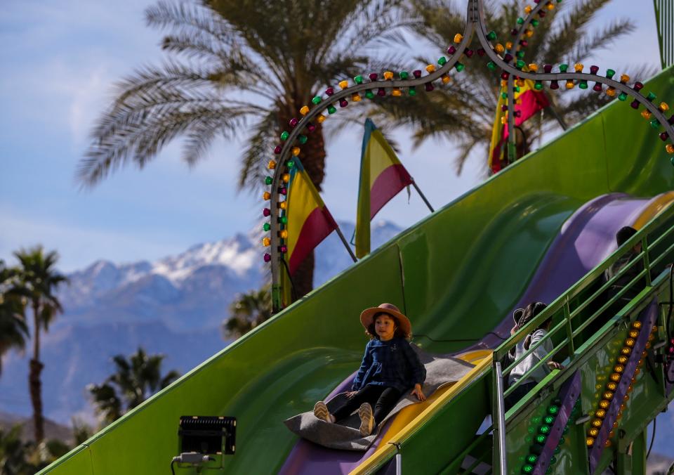 4-year-old Alejandra Gutierrez of Cathedral City goes down the super slide during the Taste of Jalisco Festival in Cathedral City, Calif., Saturday, Feb. 4, 2023. 