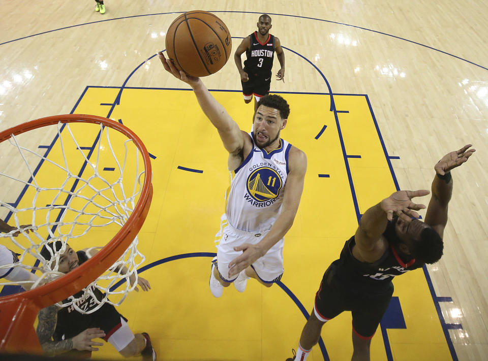 Golden State Warriors' Klay Thompson (11) lays up a shot past Houston Rockets' James Harden, right, during the first half of Game 5 of a second-round NBA basketball playoff series Wednesday, May 8, 2019, in Oakland, Calif. (Ezra Shaw/Pool Photo via AP)