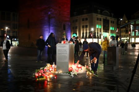 A person puts a candle at central market square in Halle