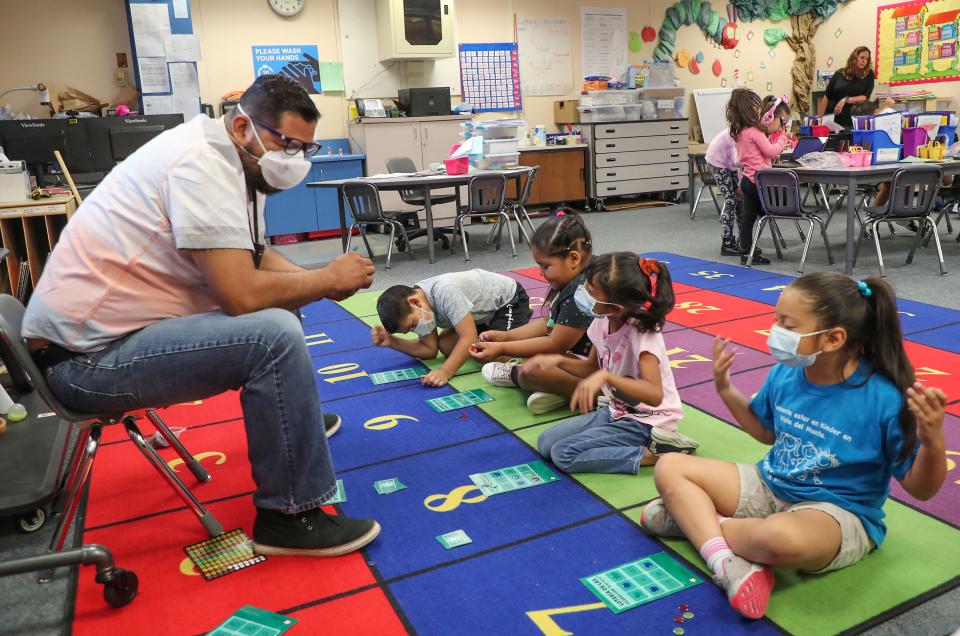 First grade teacher Cesar De La Cruz teaches his students in a dual immersion English and Spanish language in class at Vista Del Monte Elementary School in Palm Springs, Calif., May 3, 2022.