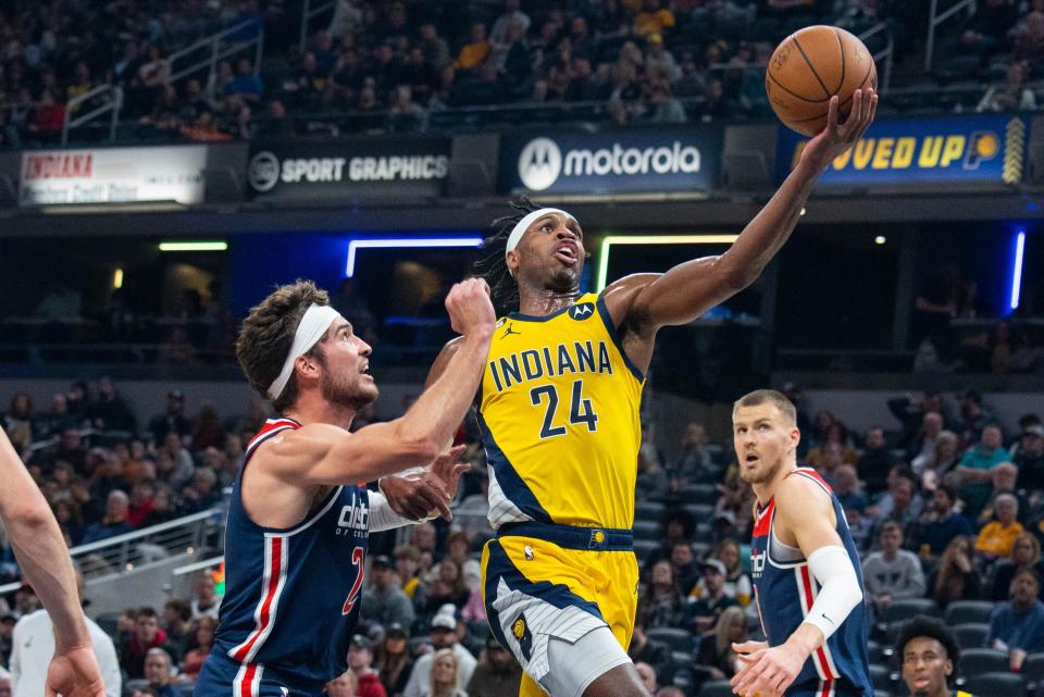 Dec 9, 2022; Indianapolis, Indiana, USA; Indiana Pacers guard Buddy Hield (24) shoots the ball while Washington Wizards forward Corey Kispert (24) defends in the first quarter at Gainbridge Fieldhouse. Mandatory Credit: Trevor Ruszkowski-USA TODAY Sports