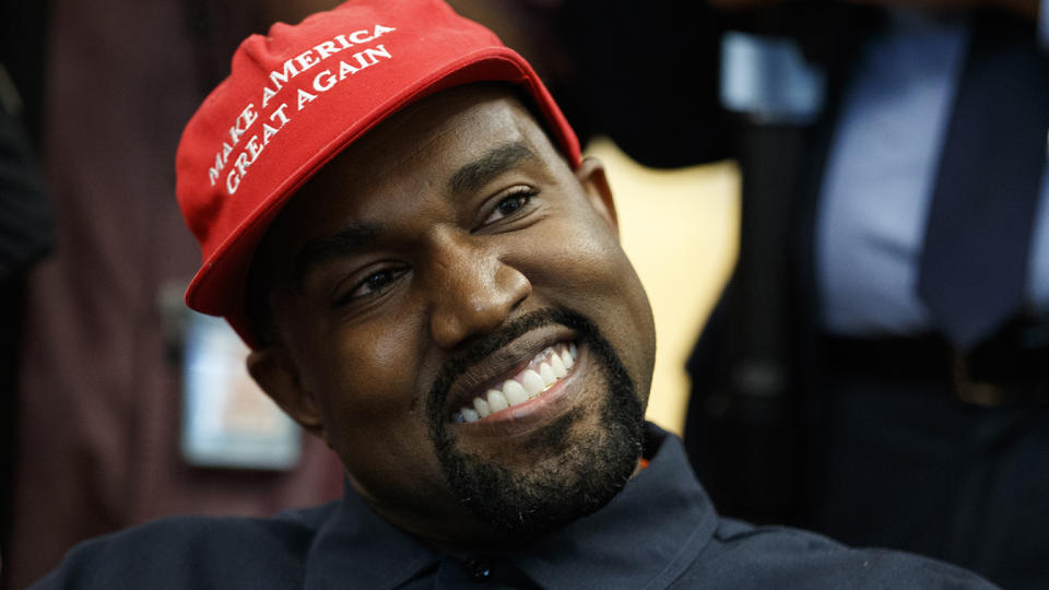 Rapper Kanye West smiles as he listens to a question from a reporter during a meeting in the Oval Office of the White House with President Donald Trump in 2018, in Washington. (Evan Vucci/AP)