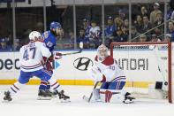 New York Rangers center Mika Zibanejad (93) scores past Montreal Canadiens goaltender Cayden Primeau (30) and defenseman Jayden Struble (47) during the third period of an NHL hockey game, Sunday, April 7, 2024, at Madison Square Garden in New York. (AP Photo/Mary Altaffer)