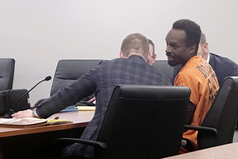 Kierre Williams, right, sits with his attorneys in court Wednesday morning, Jan. 3, 2024, in Blair, Neb. Williams is charged with fatally stabbing a small-town priest during a Dec. 10, 2023, break in at the home where the priest lived next to his church in Fort Calhoun, Neb.. (AP Photo/Josh Funk)