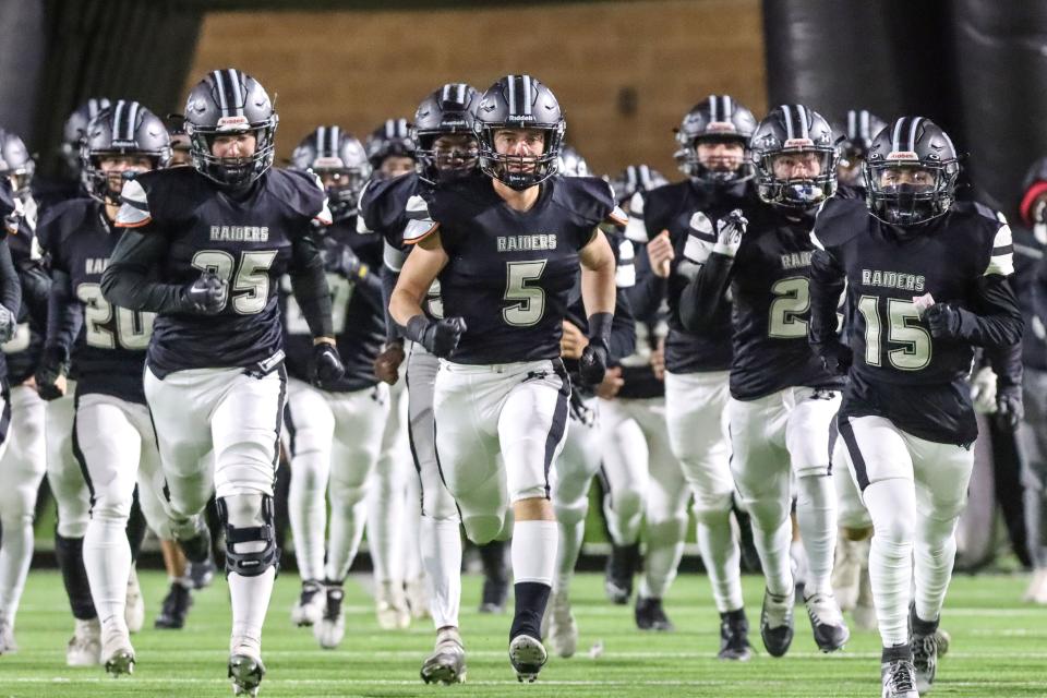 Randall’s Ilir Haliti (5) leads his team on the field  in a 4-A Division 1 Area Championship game against Estacado, Friday night, November 18, 2022, at Happy State Bank Stadium in Amarillo.  Randall won 27-14.