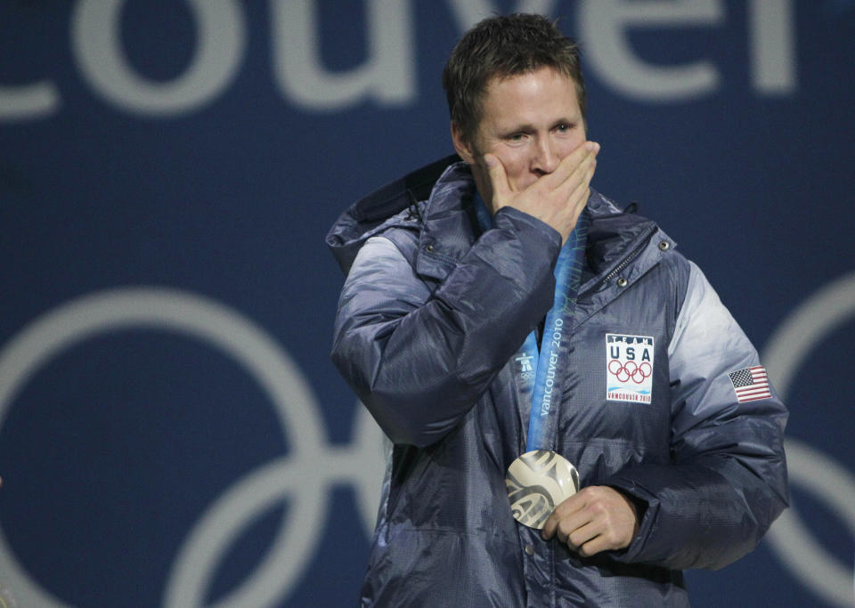 FILE - USA's silver medal winner Jeret Peterson reacts during the medals ceremony for the men's freestyle skiing aerials at the 2010 Winter Olympics in Vancouver, British Columbia on Feb. 26, 2010. Peterson took his own life at the age of 29 in 2011 just a year and a half after winning the medal. Olympians including Michael Phelps, Apolo Ohno and Jeremy Bloom are opening up about their mental health struggles in a new sobering documentary about suicide and depression among the world's greatest athletes. Many of the athletes are sharing their pain for the first time in HBO's "The Weight of Gold," which aims to expose the problem, incite change among Olympics leadership and help others experiencing similar issues feel less alone. (AP Photo/Gerry Broome)