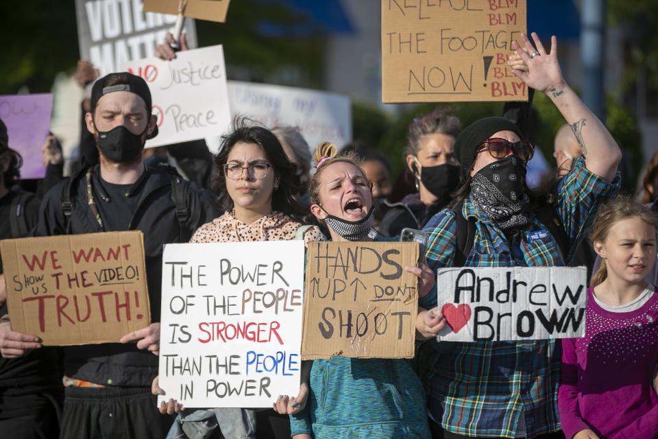 Demonstrators organize on Colonial Ave. to march, Thursday, April 22, 2021, Elizabeth City, N.C., in reaction to the death of Andrew Brown Jr., who was shot and killed by a Pasquotank County Deputy Sheriff earlier in the week. (Robert Willett/The News & Observer via AP)