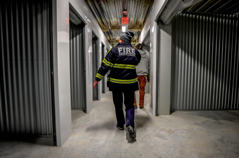 Jacqueline Davis of the Providence Fire Department inspects a new storage facility in the city for fire code compliance.