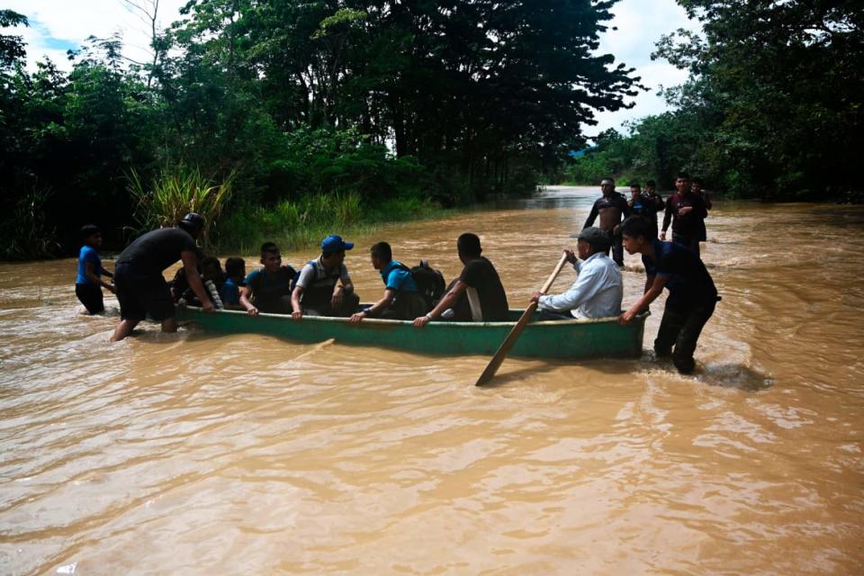 <div class="inline-image__caption"><p>People had to resort to traveling by boat in a flooded area in Panzos, Alta Verapaz.</p></div> <div class="inline-image__credit">JOHAN ORDONEZ/Getty</div>