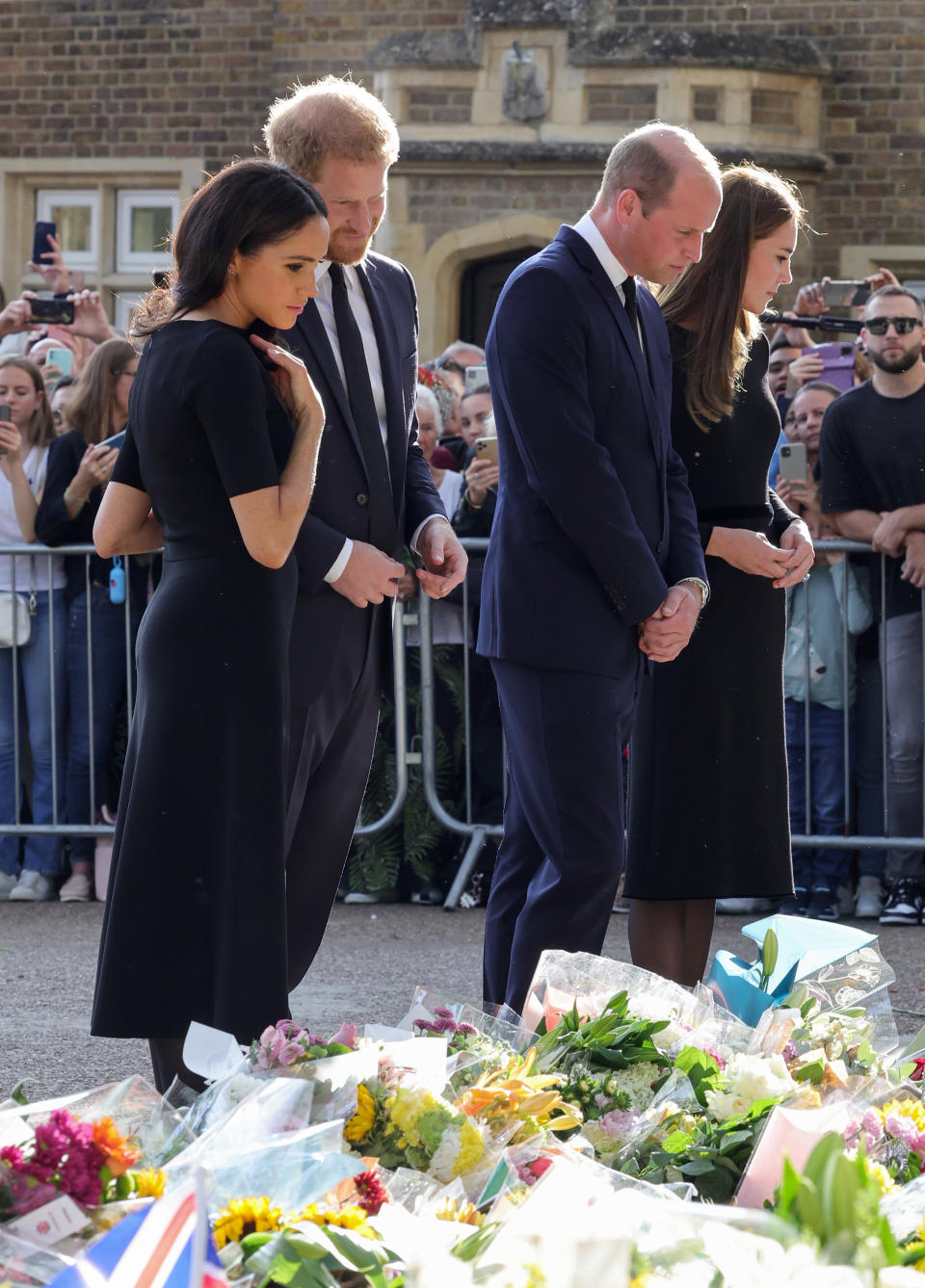 The Duke and Duchess of Sussex and the Prince and Princess of Wales view the flowers in tribute to the Queen. - Credit: Getty Images