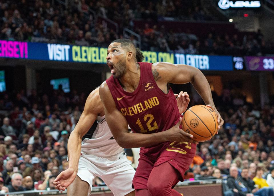 Cleveland Cavaliers' Tristan Thompson (12) drives past San Antonio Spurs' Zach Collins, left, during the second half Sunday in Cleveland.