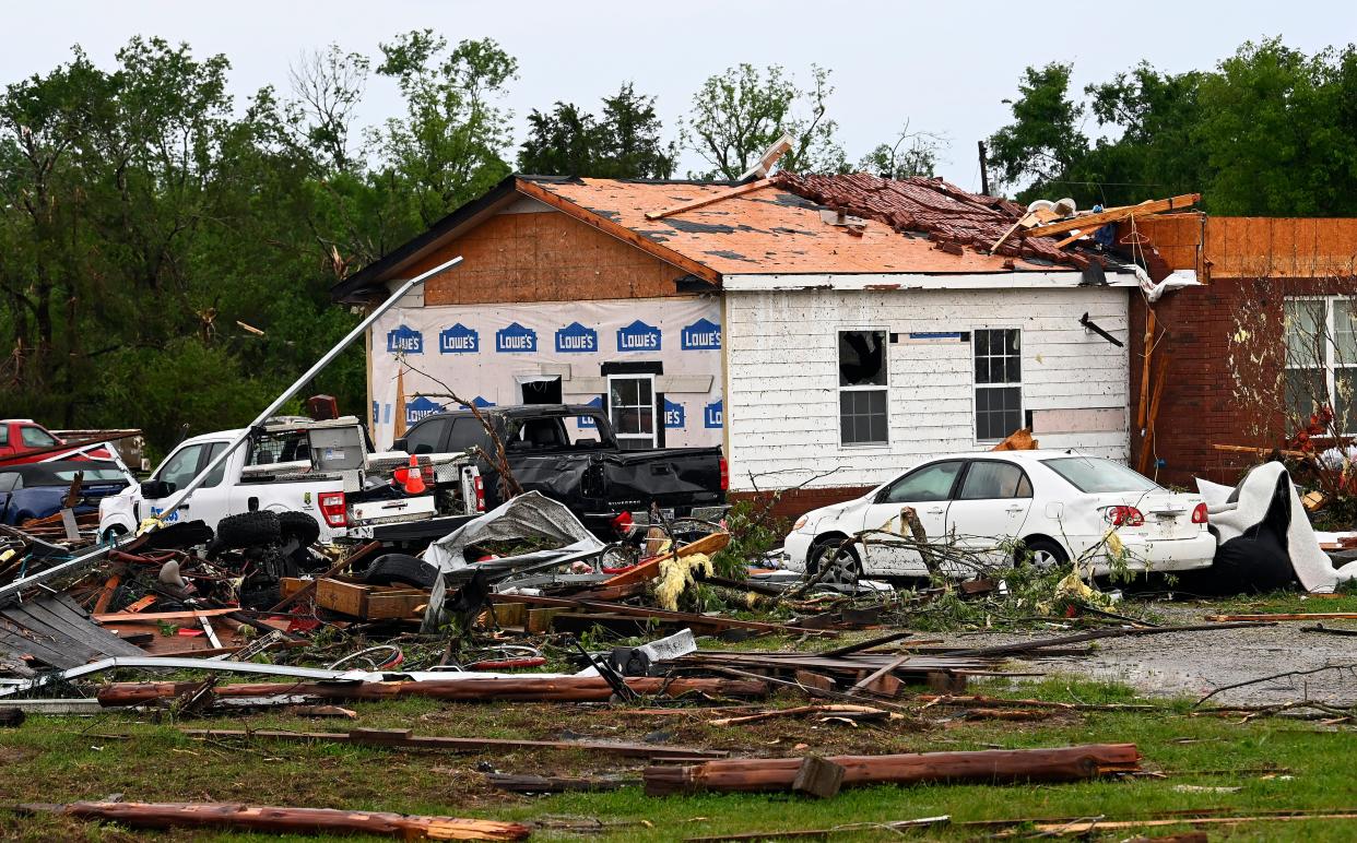 Debris surrounds a tornado-damaged home Thursday in Columbia, Tenn.