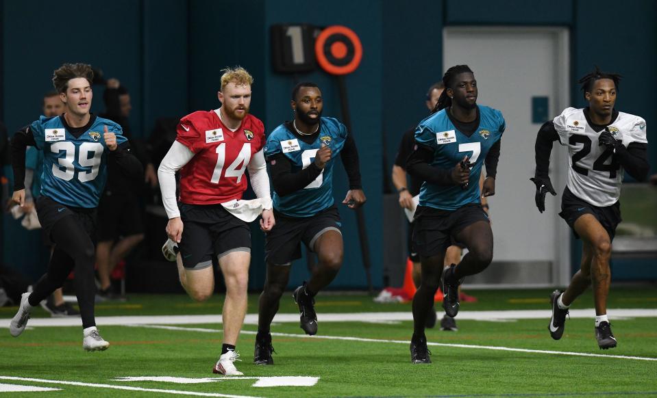 Jacksonville Jaguars kicker Cam Little (39), quarterback Brennan Armstrong (14), wide receiver Jarvis Landry (6), wide receiver Brian Thomas (7), and cornerback De'Antre Prince (24) run sprints at the end of Friday's rookie minicamp. The Jacksonville Jaguars held their first day of rookie minicamp inside the covered field at the Jaguars performance facility in Jacksonville, Florida Friday, May 10, 2024. [Bob Self/Florida Times-Union]