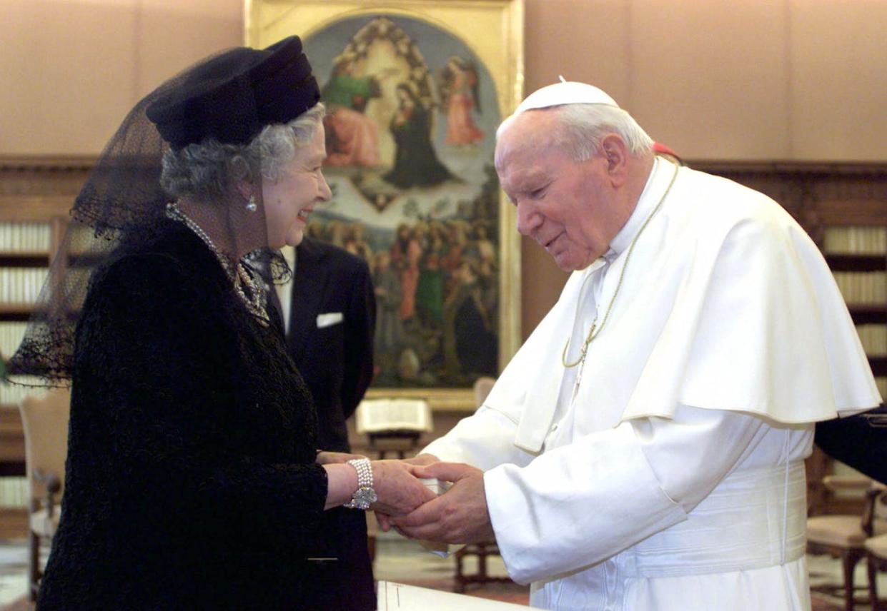 In her efforts to build a new relationship with the Catholic Church, Queen Elizabeth II had interactions with several pontiffs. She is seen here with Pope John Paul II. <a href="https://newsroom.ap.org/detail/BritainQueensReignPhotoGallery/bc023d4fdcf446b1a44081e39bf7facd/photo?Query=queen%20Pope%20John%20Paul%20II&mediaType=photo&sortBy=&dateRange=Anytime&totalCount=48&currentItemNo=20" rel="nofollow noopener" target="_blank" data-ylk="slk:AP Photo/Alessandro Bianchi, Pool, File;elm:context_link;itc:0;sec:content-canvas" class="link ">AP Photo/Alessandro Bianchi, Pool, File</a>