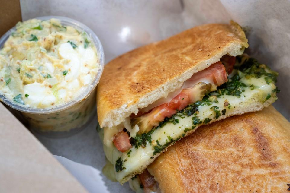 The Caprese panini is a popular choice, shown with a side of Vern's potato salad, at FEAST in Eustis.