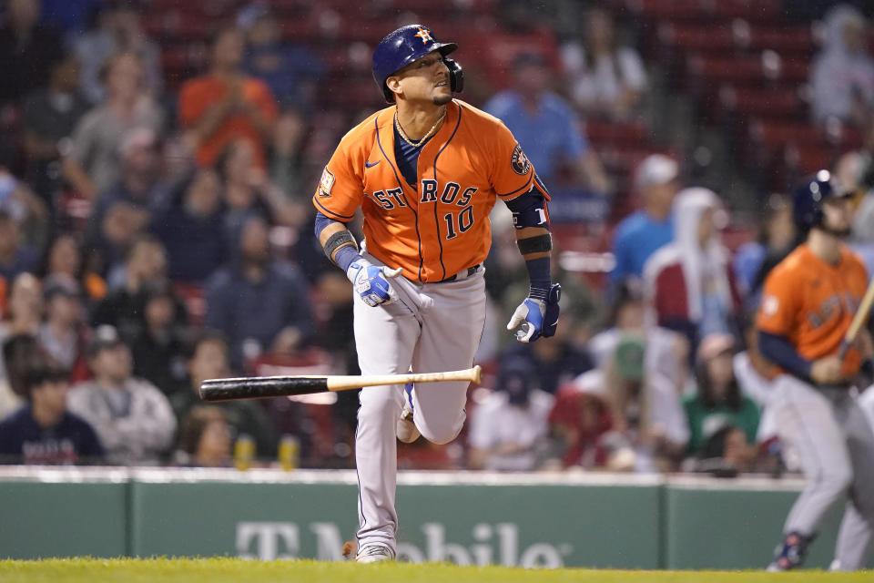 Houston Astros' Yuli Gurriel hits a pop fly allowing Houston Astros' Michael Brantley to score in the sixth inning of a baseball game against the Boston Red Sox, Monday, May 16, 2022, in Boston. (AP Photo/Steven Senne)