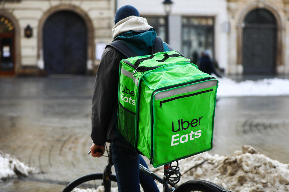 Uber Eats delivery courier is seen riding a bicycle in the center of Krakow, Poland. January 20th, 2021. As restaurants remain closed in Poland due to the coronavirus pandemic lockdown, ordering food online has bacame extremely popular in large cities.  (Photo by Beata Zawrzel/NurPhoto via Getty Images)