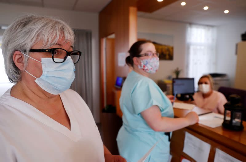 Health workers wear protective face masks as they work at La Roseliere retirement home (EHPAD) in Kunheim