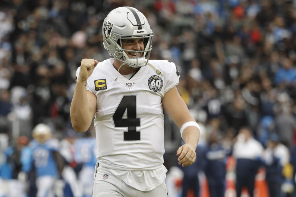 Oakland Raiders quarterback Derek Carr celebrates after a touchdown by running back DeAndre Washington during the second half of an NFL football game against the Los Angeles Chargers Sunday, Dec. 22, 2019, in Carson, Calif. (AP Photo/Marcio Jose Sanchez)