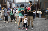 Residents visit a weekend open air market in Beijing on Saturday, Aug. 8, 2020. As the coronavirus outbreak comes under control in the Chinese capital, normal life is slowing returning albeit with the requisite masks. (AP Photo/Ng Han Guan)