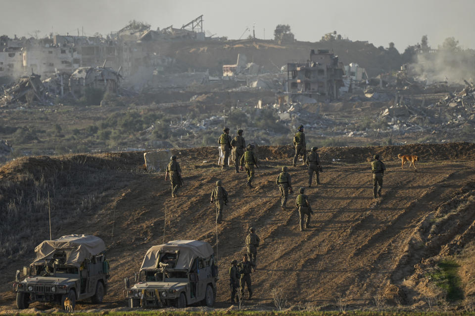 Israeli troops are seen near the Gaza Strip border, in southern Israel, Monday, Dec. 11, 2023. The army is battling Palestinian militants across Gaza in the war ignited by Hamas' Oct. 7 attack into Israel. (AP Photo/Ohad Zwigenberg)