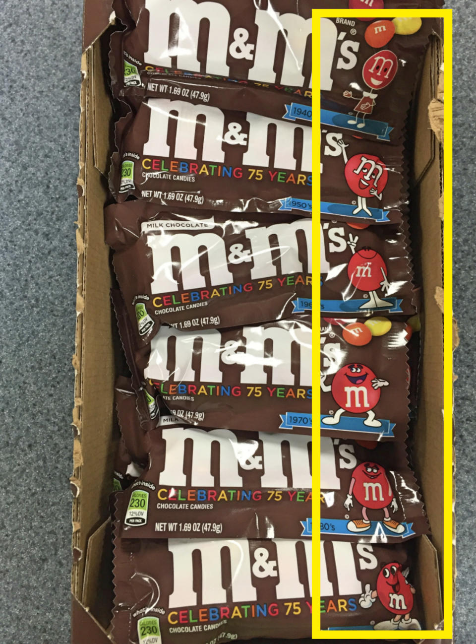 Six packs of M&M's are displayed in a box, each labeled with "M&M's Celebrating 75 Years" and featuring the signature M&M characters