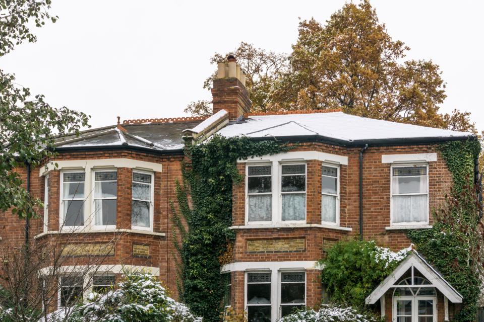 house prices Fall of snow shows different levels of insulation in semi-detached roofs. House on the right has an insulated loft, so heat from house has not melted snow.