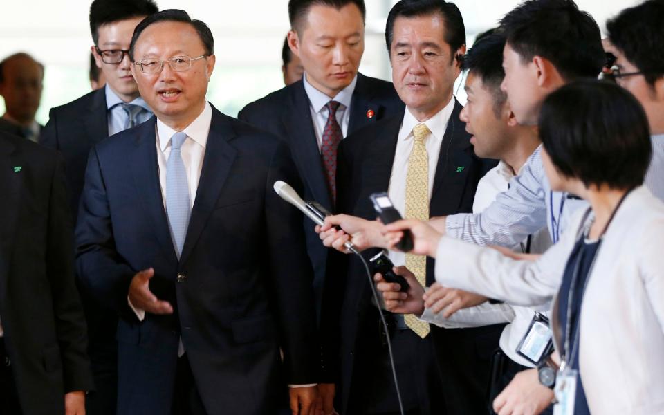 China's State Councillor Yang Jiechi, front left, is surrounded by media after meeting with Japan's Prime Minister Shinzo Abe at Abe's official residence in Tokyo, Japan Wednesday, May 31, 2017. - Credit: Reuters/Pool