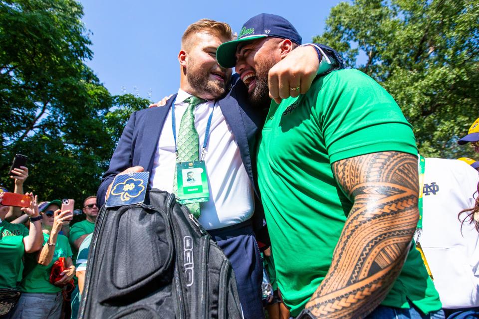 Hunter Bivin hugs Manti Te’o before the Notre Dame vs. California NCAA football game Saturday, Sept. 17, 2022 at Notre Dame Stadium in South Bend.