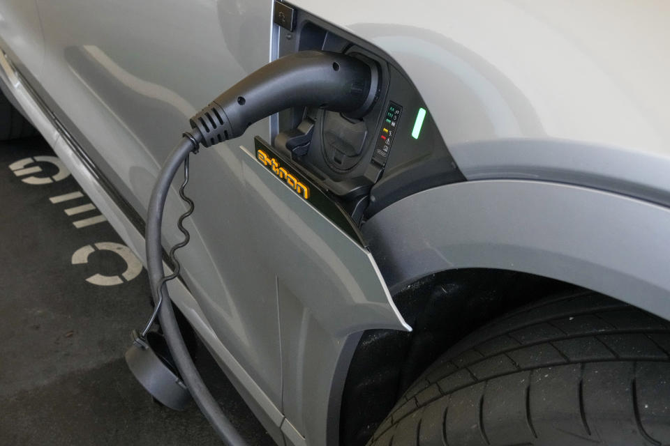 An electric car gets charged at a supermarket carpark in Sydney, Australia, Tuesday, Nov. 9, 2021. Australia’s prime minister on Tuesday announced plans to encourage people to buy electric vehicles weeks after his government was accused at a U.N. conference in Scotland of being a laggard in fighting climate change. (AP Photo/Mark Baker)