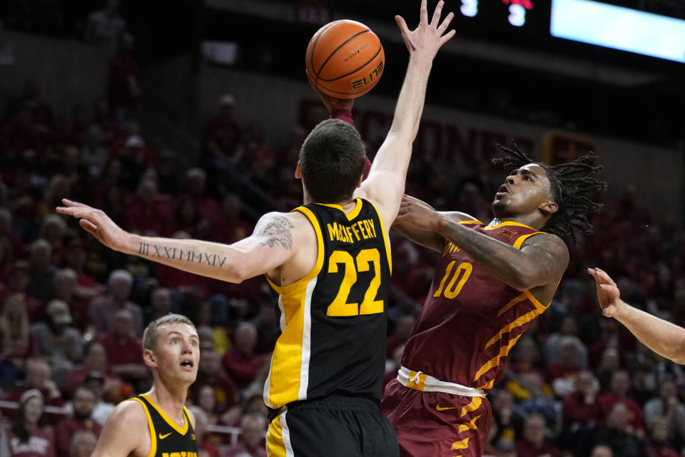 Iowa State guard Keshon Gilbert (10) shoots over Iowa forward Patrick McCaffery (22) during the second half of an NCAA college basketball game, Thursday, Dec. 7, 2023, in Ames, Iowa. (AP Photo/Charlie Neibergall)