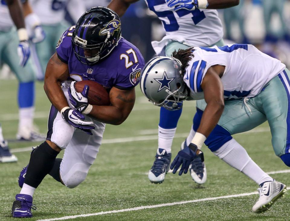 Baltimore Ravens running Ray Rice (27) gets hit by the Dallas Cowboy’s J.J. Wilcox during a game on Aug. 16, 2014, in Arlington, Texas. 