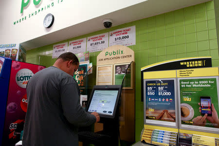 Puerto Rican Jose E. Torres fills out a job application at a supermarket after receiving a notification that he does not qualify for aid provided by the state to Puerto Ricans who were affected by Hurricane Maria, in Orlando, Florida, U.S., December 13, 2017. REUTERS/Alvin Baez