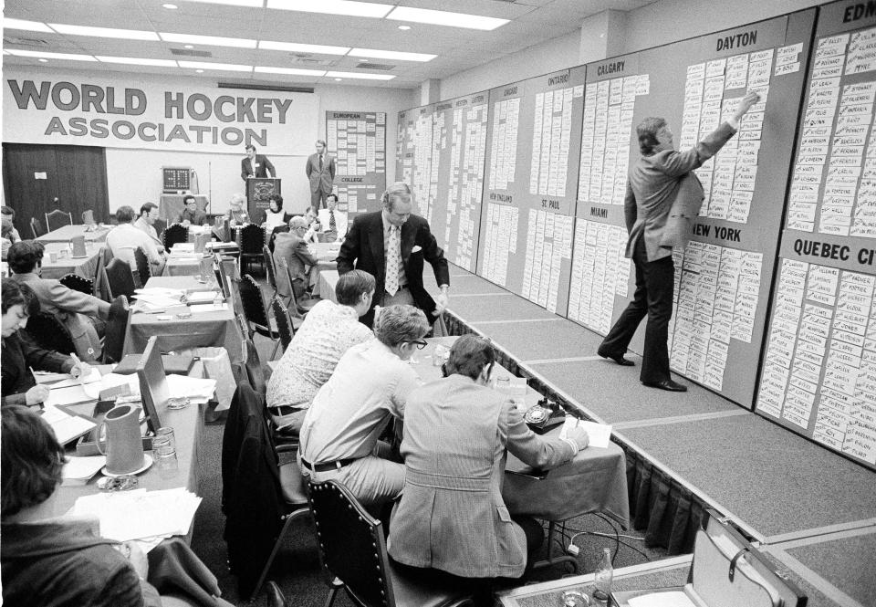 FILE - The World Hockey Association conducts its first draft in Anaheim, Calif., Feb. 13, 1972. The American Basketball Association and World Hockey Association have been gone for decades, but their brash challenges to the set-in-their-ways NBA and NHL left a mark that is still recognizable today. (AP Photo/File)