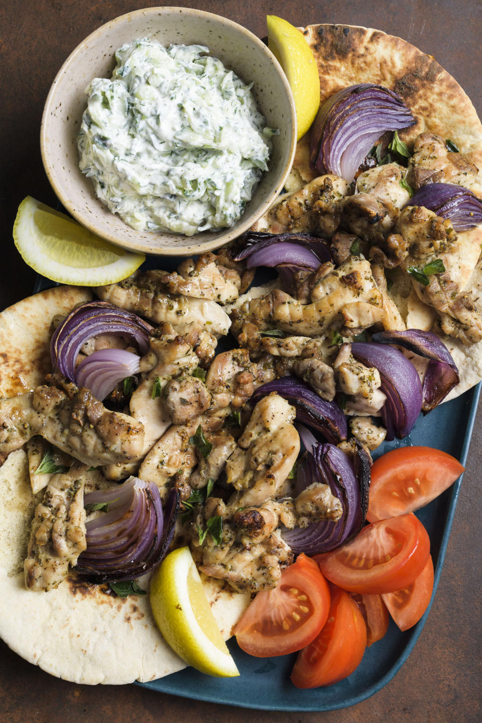 This image released by Milk Street shows a recipe for chicken souvlaki with tzatziki. (Milk Street via AP)